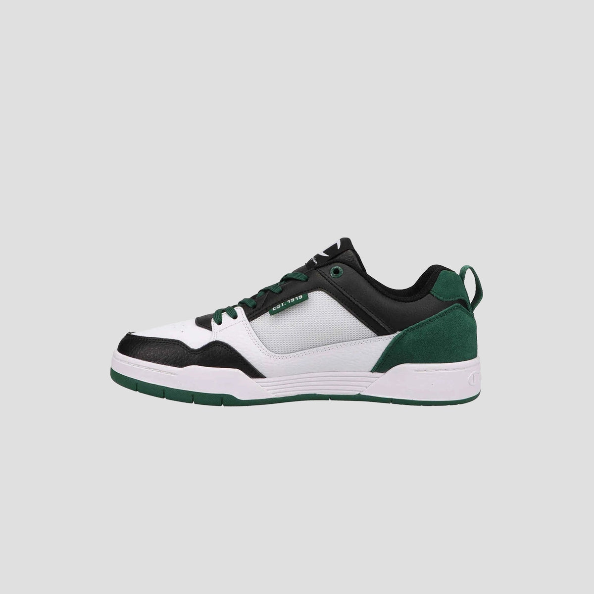 The Champion Men's 5-on-5 Low is a minimalist low-top sneaker with a white mesh upper, black leather overlays, green suede heel accents, green laces, cushioned collar, and a white and green rubber sole on a light gray background.