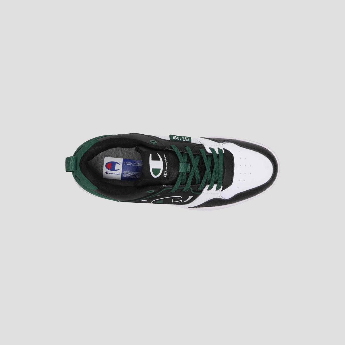 Top view of the Champion Men's 5-on-5 Low sneaker in black, white, and dark green with laces, cushioned collar, and Champion logo on the side and tongue, set against a plain light grey background for a minimalist look.