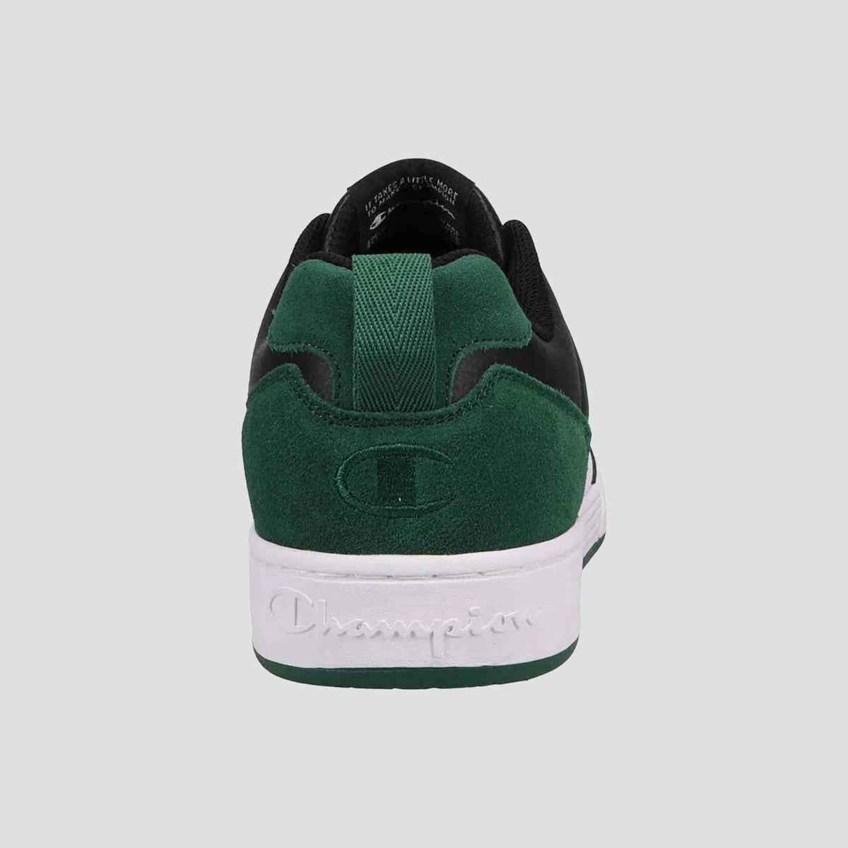 The Champion Men's 5-on-5 Low sneaker in green and black is shown from the back, featuring a cushioned collar, suede heel embossed with a logo, and a white sole with "Champion" written on it.