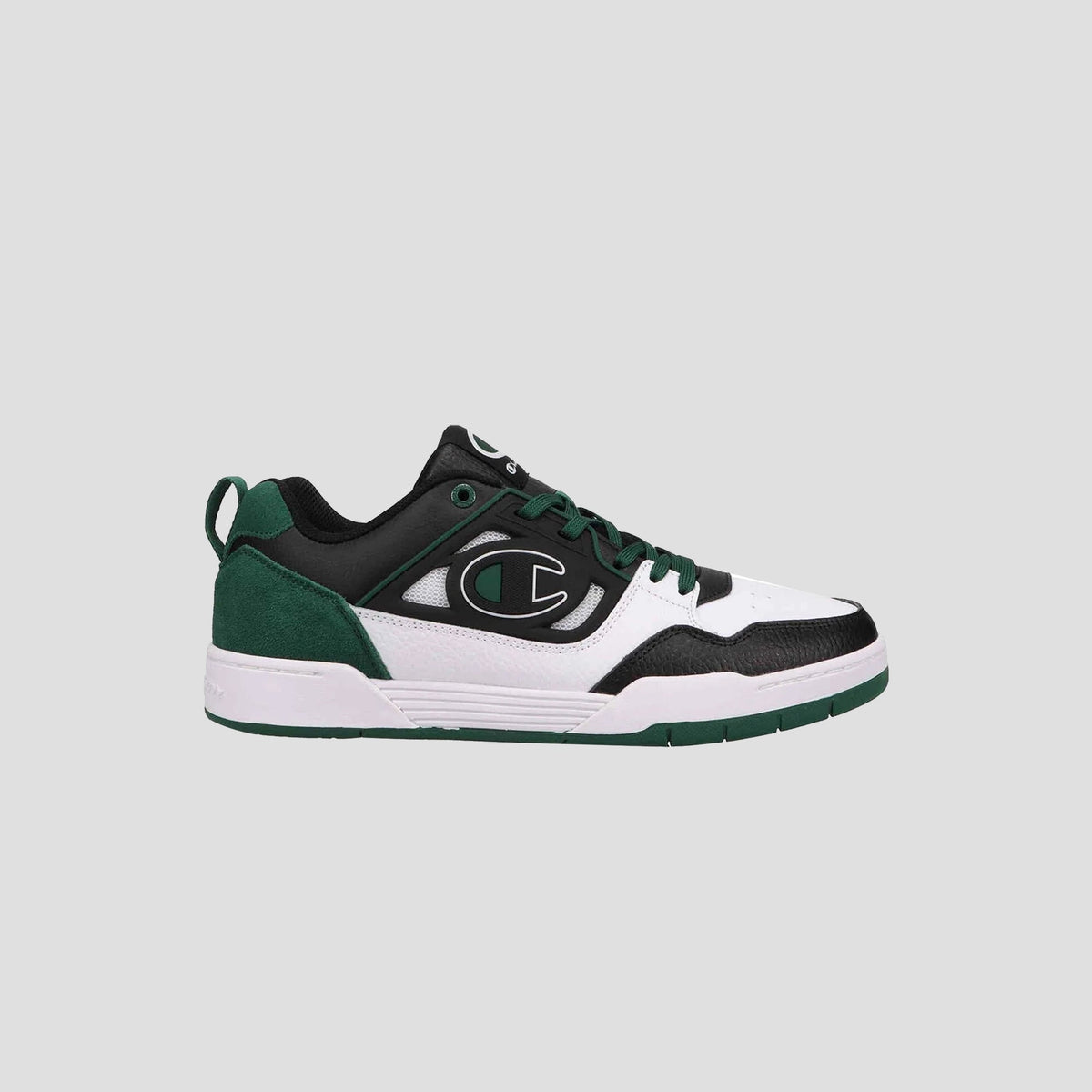 The Champion Men's 5-on-5 Low sneaker in black, white, and dark green sports a minimalist design with a large C logo, cushioned collar, green laces, and a white/green sole. Set against a light gray background.