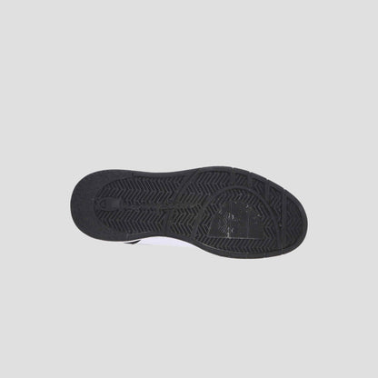 The image shows the black rubber outsole of the Champion Women's 5-on-5 Low sneaker against a light gray background, featuring textured tread patterns for grip and traction with a sleek, minimalist design.