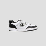 The Champion Women's 5-on-5 Low is a white and black sneaker with a minimalist design, thick sole, lace-up front, cushioned collar, and a bold C logo on the side, shown against a plain light gray background.