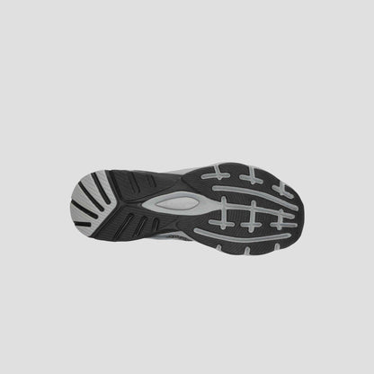 The image shows the bottom view of a black and gray Champion Men's Alpha athletic shoe sole, featuring a textured tread for grip and support—perfect for gym workouts or everyday men's sneakers.