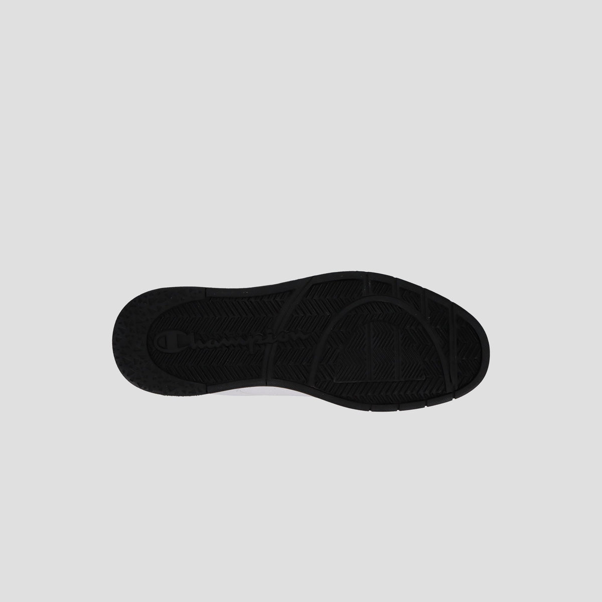 The Champion Men's 3-on-3 Court Low sneaker is shown with its sole lying flat on a light gray background, highlighting the tread pattern and texture details of the bottom.