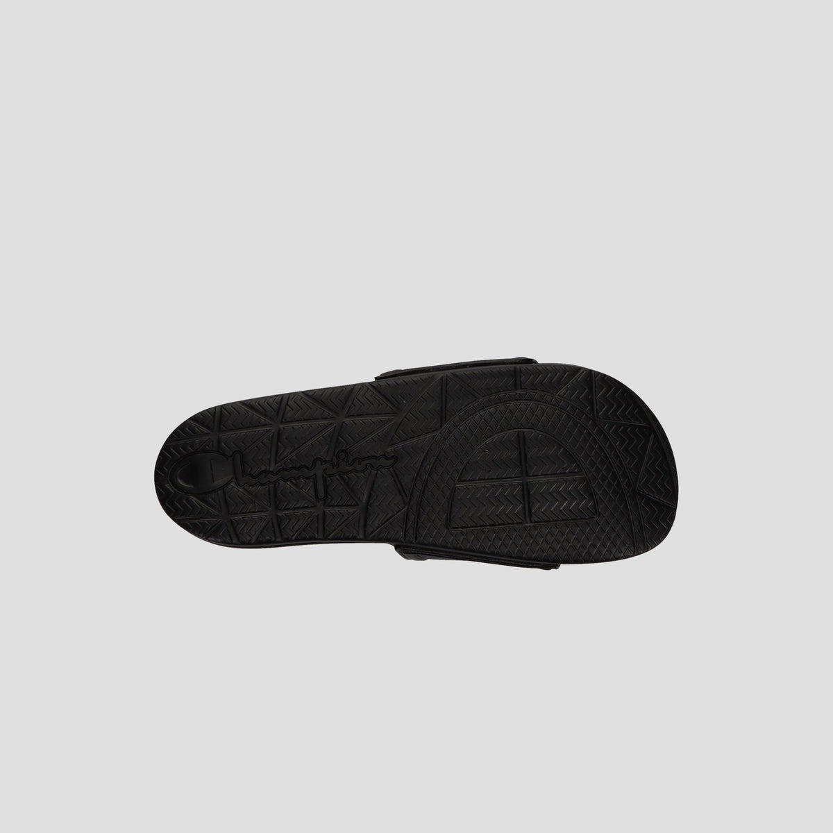 The image shows the bottom view of a black Champion Men's IPO Squish Slide sandal with a textured, geometric-patterned sole and embossed branding on a plain light gray background.