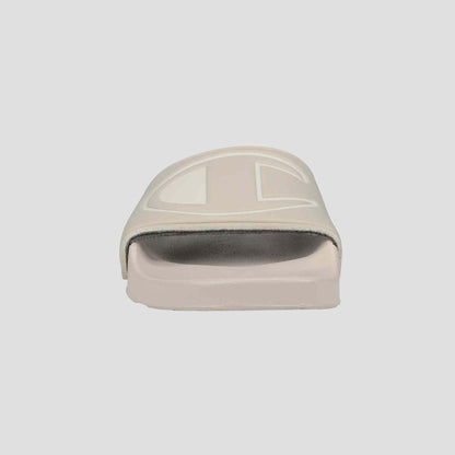 A front view of the Champion Women's IPO Slide in light beige, featuring a thick strap and slightly elevated sole with a contoured footbed for lightweight comfort, set against a plain white background.
