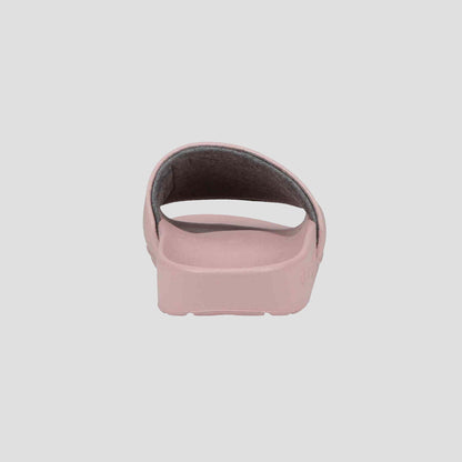 A rear view of the Champion Women's IPO Slide in light pink shows its open back, single thick top strap, and contoured footbed, all set against a plain light gray background.