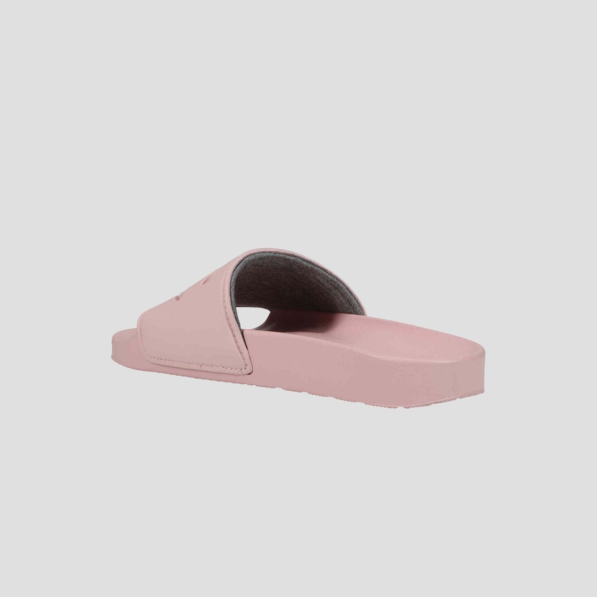 The Champion Women's IPO Slide is displayed in pink with a contoured footbed, open toe, and wide strap, viewed from a low rear angle against a plain white background.