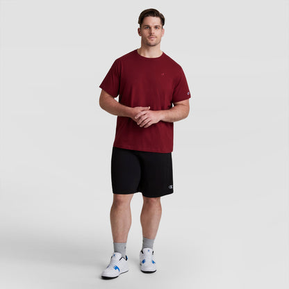 A man wearing a maroon t-shirt and black Champion 10″ Moisture Wicking, Sport Shorts - Big & Tall.