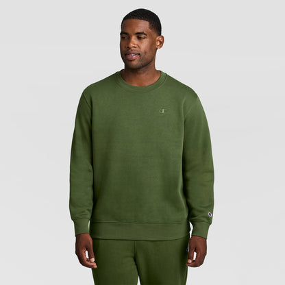 A man wearing an olive green Powerblend Crewneck Sweatshirt, C Logo - Big & Tall with a small logo on the chest and matching sweatpants.
