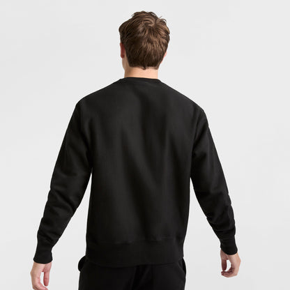 A person with short brown hair is shown from the back wearing a Champion Reverse Weave Crewneck Sweatshirt, C Logo, and black heavyweight fleece pants against a white background.