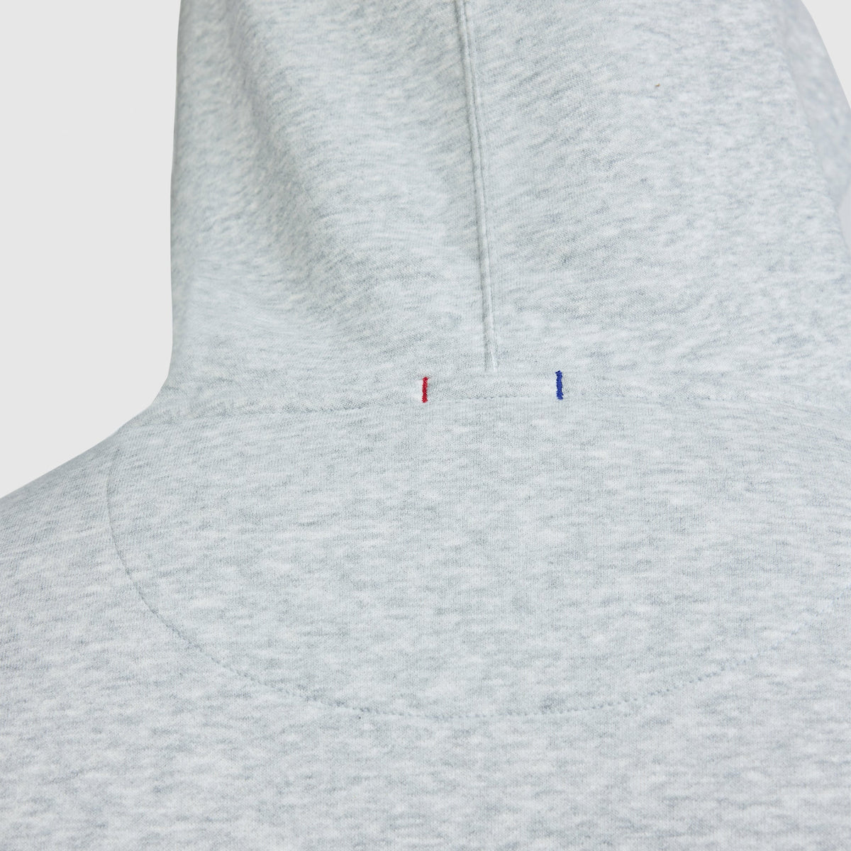 Light gray heathered midweight Champion Powerblend Hoodie, Full Script Logo - Big & Tall featuring two small, vertical embroidered dashes in red and blue at the base of the hood.