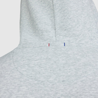 Light gray heathered midweight Champion Powerblend Hoodie, Full Script Logo - Big & Tall featuring two small, vertical embroidered dashes in red and blue at the base of the hood.