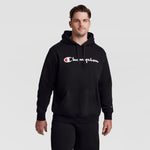 A man wearing a Champion Powerblend Hoodie, Full Script Logo - Big & Tall featuring a soft fleece pullover design with a large white and red logo on the chest.