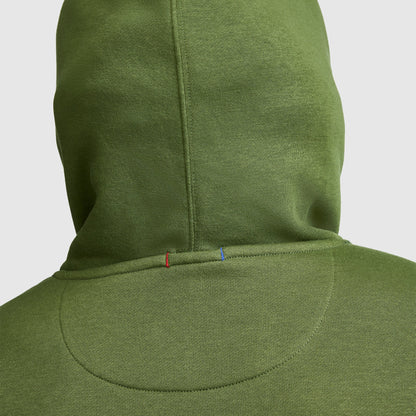 The back view of the Champion Powerblend Hoodie, Full Script Logo features a seam adorned with small red and blue stitches near the neckline, set against a plain light background.