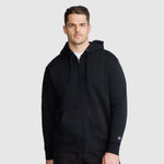 A man wearing a black Champion Powerblend Full-Zip Hoodie, C Logo - Big & Tall with a hood and pockets stands against a light gray background, looking at the camera with a neutral expression.