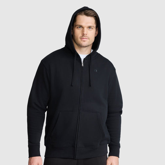 A man wearing a Champion Powerblend Full-Zip Hoodie, C Logo - Big & Tall with the hood up, standing against a plain light gray background.