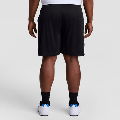 A person is standing facing away from the camera against a plain light background, wearing white sneakers, black socks, a white shirt, and Champion 9" Classic Mesh Shorts with C Logo - Big & Tall.