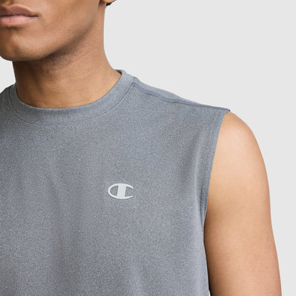 A person is shown from the shoulders up against a plain light background, wearing the Champion Sport Muscle Tank with a reflective C logo on the chest. This men’s muscle tank is made with moisture-wicking fabric to help keep you comfortable during any workout.