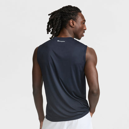 A man with long, braided hair is seen from the back wearing Champion’s Sport Muscle Tank with a reflective C logo, paired with white shorts, set against a plain white background—an ideal men’s workout top.