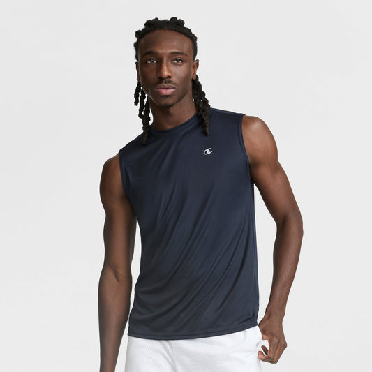 A man wearing a Champion Sport Muscle Tank with a reflective C logo and white shorts stands against a plain white background.