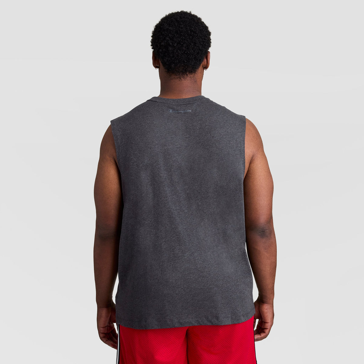 Back view of a person wearing a charcoal gray Muscle Tank, C Logo - Big & Tall and red athletic shorts.