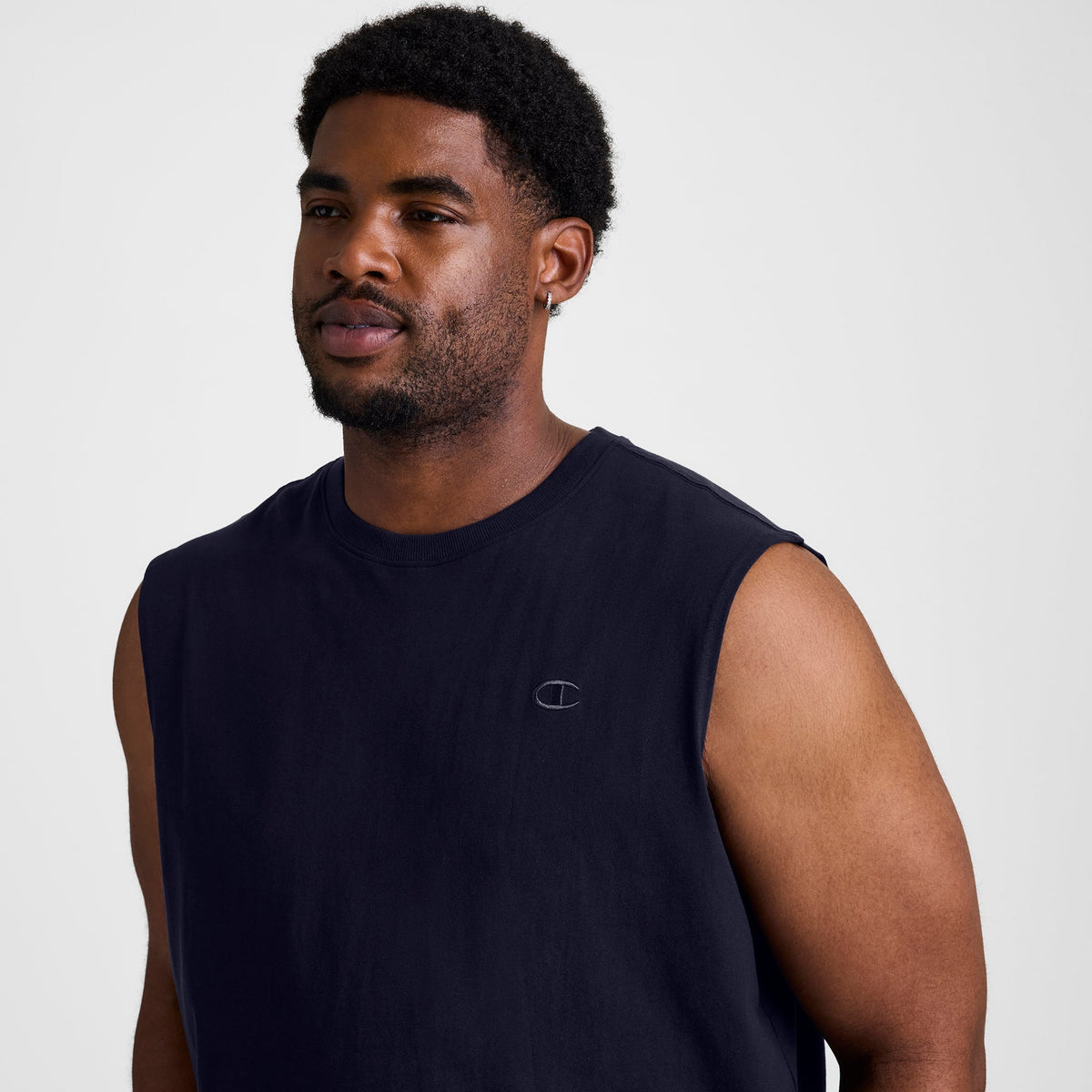 A man wearing a black Muscle Tank, C Logo - Big & Tall sleeveless muscle tee with a small logo on the chest.