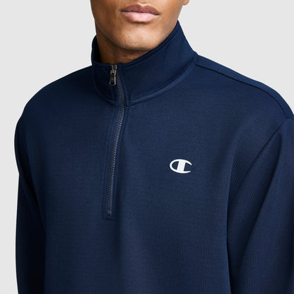 A person wears the Champion Sport Long Sleeve 1/4 Zip Mockneck, featuring a small white C logo on the left chest, set against a plain light background.