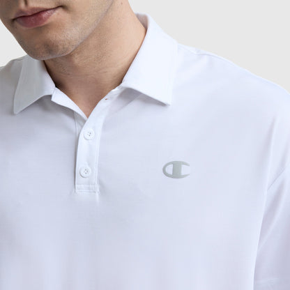 A person wears a white Champion Sport Polo, featuring three buttons and a small silver C logo on the left chest. The image highlights its athletic style, focusing on the upper torso and part of the face against a plain background.