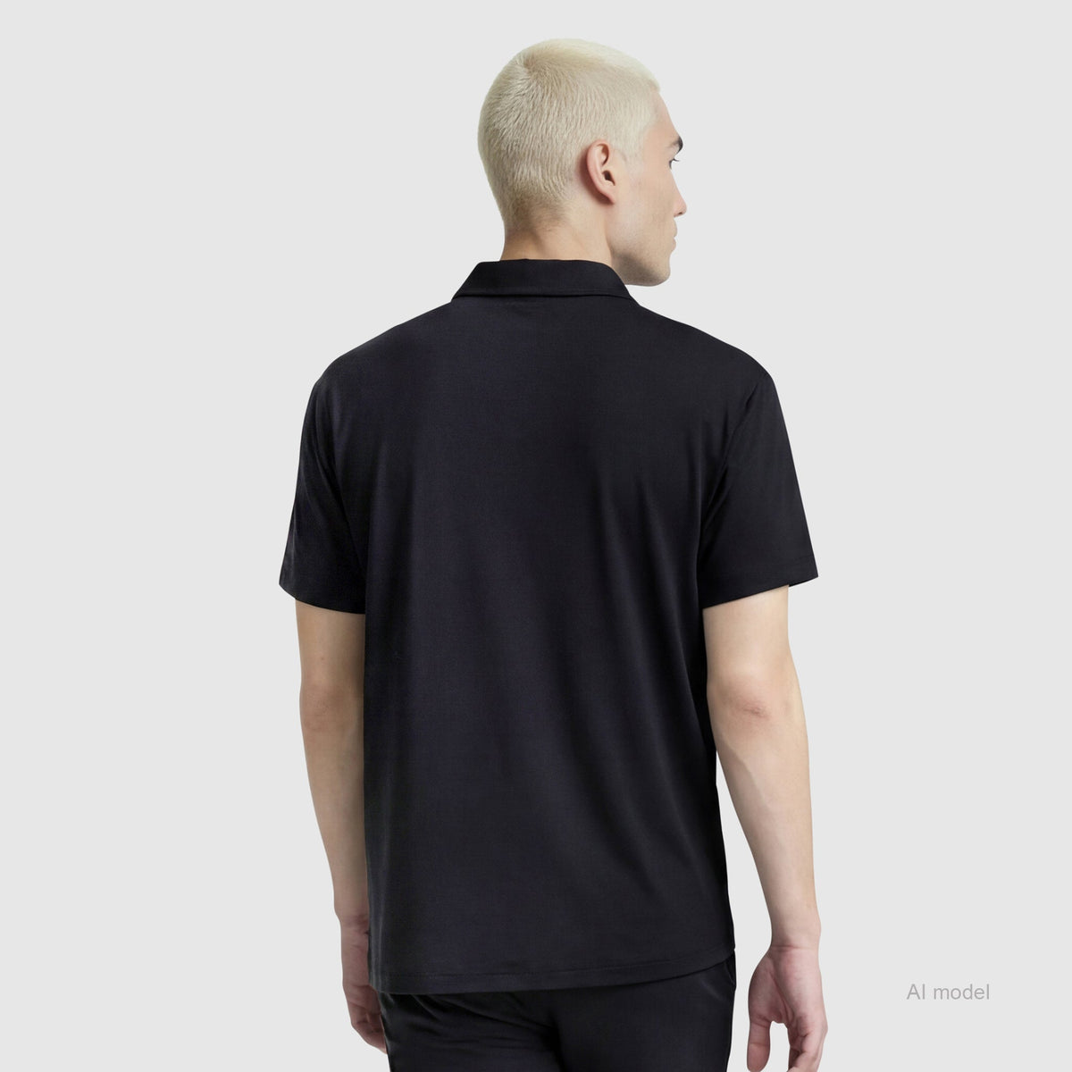 A person with short, light blonde hair is shown from the back wearing a black Champion Sport Polo with C Logo and black pants, standing against a plain light gray background.