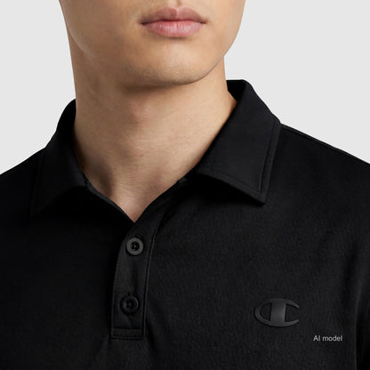 A person wears the Champion Sport Polo, C Logo—a black athletic polo with a small chest logo. The image highlights its sporty four-way stretch design, showing only the lower face and upper torso against a plain background.
