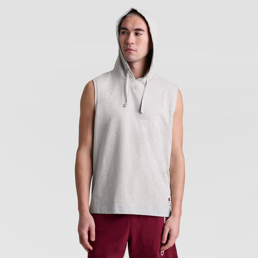 A person wears a Champion Sleeveless Hoodie with an embroidered C logo, hood up, and maroon shorts, standing facing forward against a plain light background.