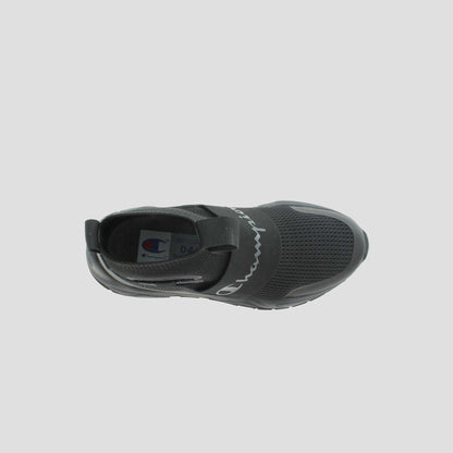 Top view of the Champion Kids' Rally Pro: a black slip-on athletic shoe with mesh details, elastic band across the midfoot, rounded toe, and Champion logo on both the insole and band. No visible laces for easy wear.