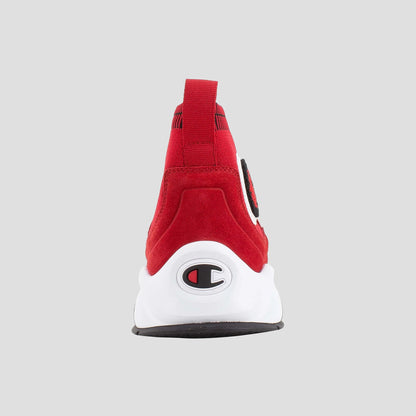 The Champion Men's Rally Pro is a red sock-style sneaker with a white sole, black and white Champion logo on the heel, pull tab at the top, and gray background—a stylish and comfortable choice for standout sneaker fans.