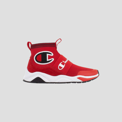 The Champion Kids' Rally Pro is a red high-top sneaker featuring a sock-like knit ankle, black and white Champion logo on the side, white midsole, and black outsole, shown against a plain light gray background.
