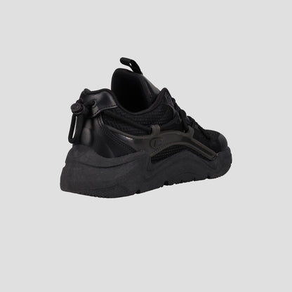 The Champion Men's Hyper C Pilot W is a black lifestyle sneaker with a chunky sole, durable mesh upper, and leather details, shown from a rear angled view against a plain gray background.