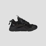 The Champion Men's Hyper C Pilot W is a black lifestyle sneaker with a chunky sole, mesh upper, synthetic overlays, lace-up front, and pull tab at the heel, shown in side profile against a plain light gray background.