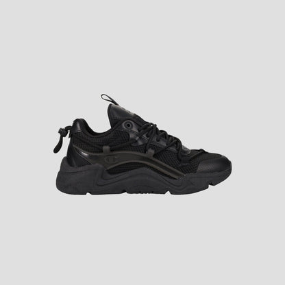 The Champion Men's Hyper C Pilot W is a black lifestyle sneaker with a chunky sole, mesh upper, synthetic overlays, lace-up front, and pull tab at the heel, shown in side profile against a plain light gray background.