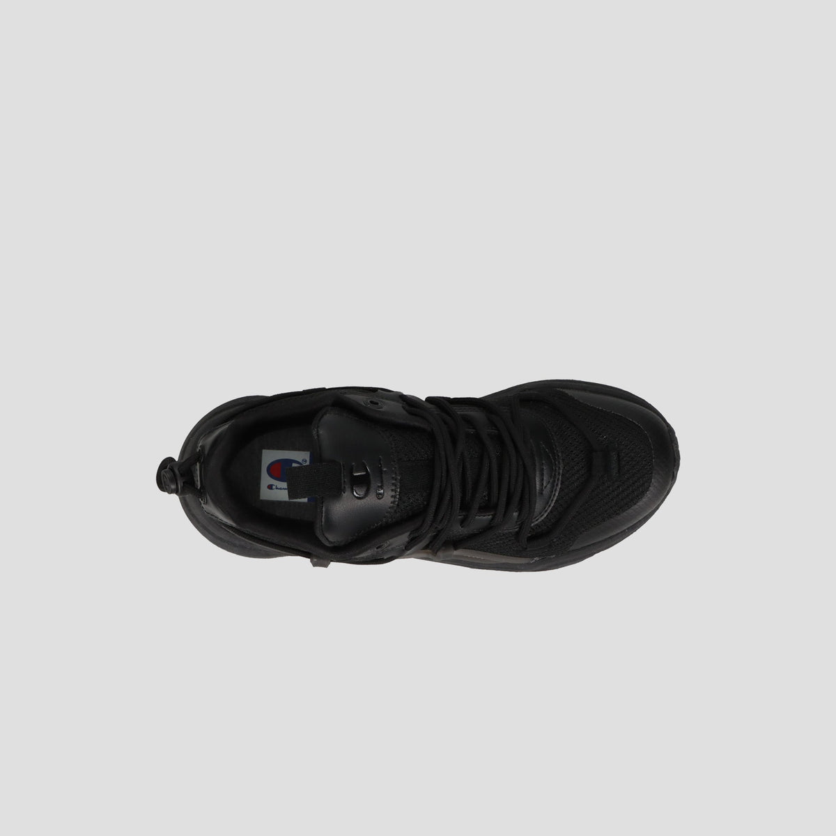 Top view of the Champion Men's Hyper C Pilot W sneaker in black, featuring a lace-up design, durable mesh upper, textured toe, and visible logo on the insole against a light gray background.