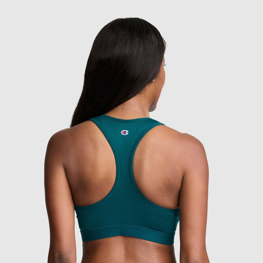 A woman with long dark hair is shown from the back wearing the Champion Compression Sports Bra, C Logo—a teal racerback women’s bra designed for moderate support with moisture-wicking fabric—standing out against a plain light gray background.