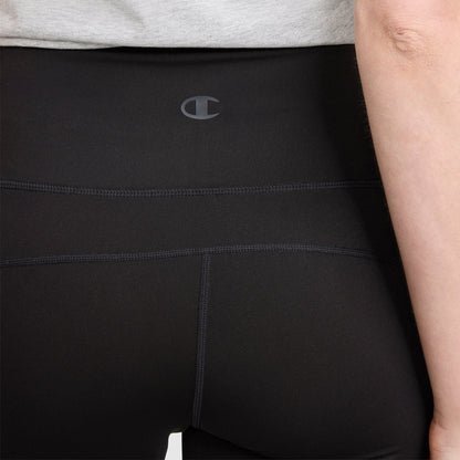 A close-up of a person wearing Champion Soft Touch Flare Leggings with anti-odor technology, featuring visible stitching and a small C logo on the waistband. The person is standing against a plain background.