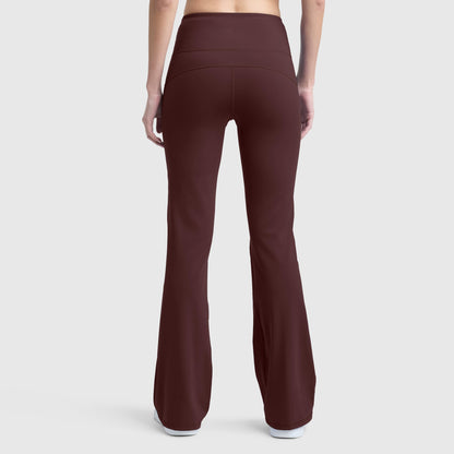 A person is shown from the back wearing Champion Soft Touch Flare Leggings, featuring a high-waisted fit in maroon with anti-odor technology and a C logo, paired with white shoes against a plain light gray background.