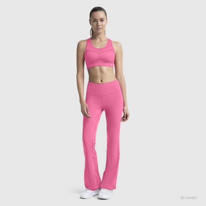 A woman in a Champion Seamless Racerback Sports Bra and flared leggings stands facing forward, long hair tied back, wearing white athletic shoes against a plain light gray background.
