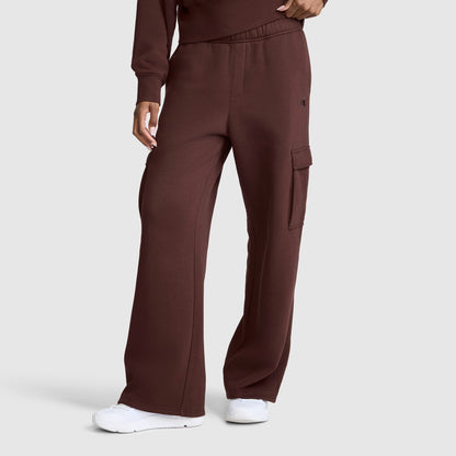 A person wearing Champion Fleece Cargo Training Pant in brown, paired with a matching top and white sneakers, stands against a plain gray background.