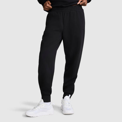 A person wearing the Champion Taper Leg Jogger with Zippers and white sneakers stands against a plain background, with hands partially visible at the waist.