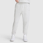 A person wearing Champion Taper Leg Jogger with Zippers in light gray, featuring a tapered jogger fit, paired with white sneakers; shown from the shoulders down against a plain background.