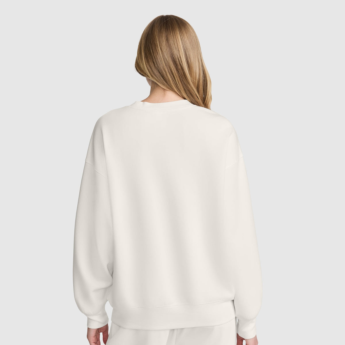 Back view of a person wearing a plain white Champion Crewneck Pullover Sweatshirt with an athletic silhouette.