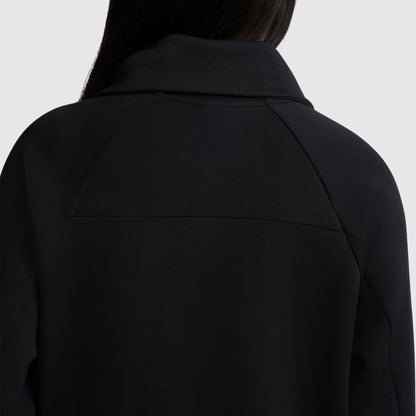 Back view of a person wearing the Champion Quarter-Zip Pullover in black, featuring a wide collar that frames the upper shoulders and neck against a light gray background. The person's partially visible long dark hair emphasizes the pullover’s sleek silhouette.