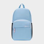 The Champion Luna Backpack is a light blue everyday backpack featuring a front zip pocket, pink zipper pulls, black side mesh pockets, and a top handle. Designed for convenience, it includes an interior laptop sleeve and showcases the word "Champion" embroidered in white and pink on the front pocket. This minimalist backpack blends style with functionality for daily use.
