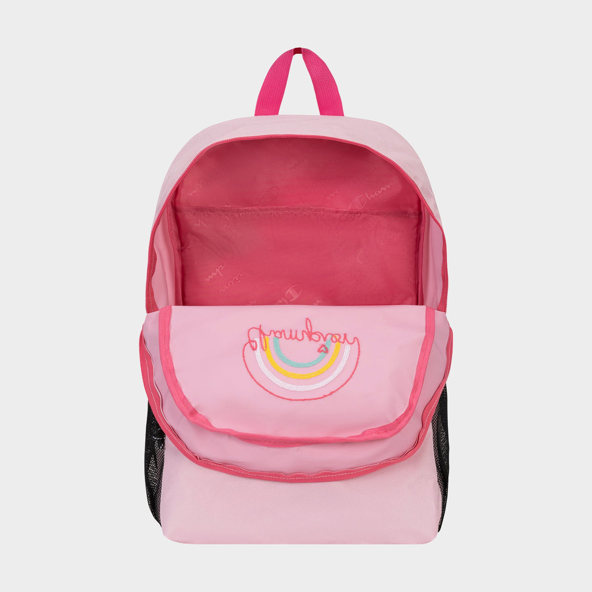 The Champion Kids' Merit Backpack is a pink, durable polyester bag with a front pocket featuring an embroidered "strawberry" and rainbow, light pink interior, black mesh side pockets, and a pink handle—perfect for kids' sports.